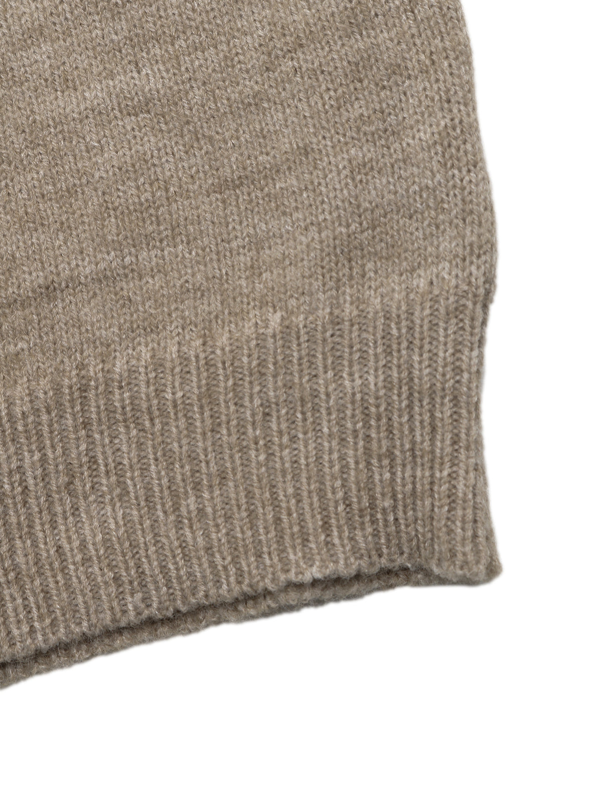 Close-up of a ribbed knit fabric cuff in a warm taupe-beige color, showing the texture and stitching detail against a plain white background.