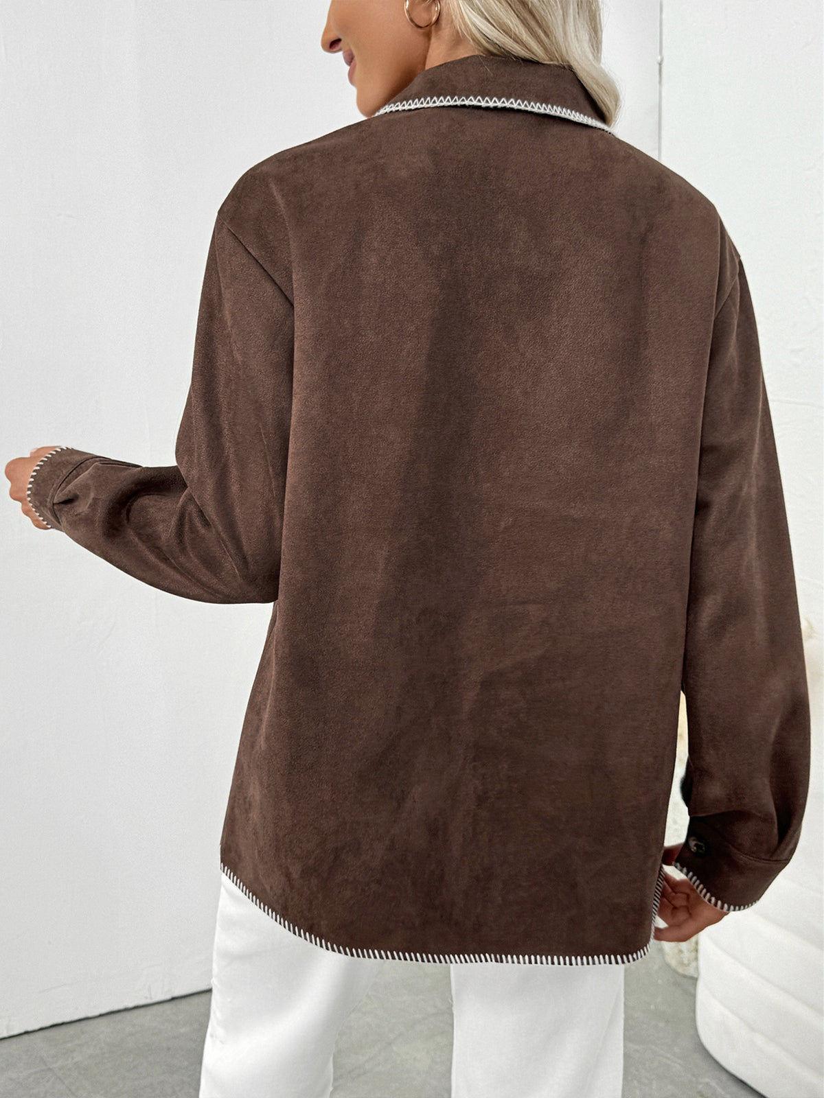 Brown suede jacket worn by a person on a white background