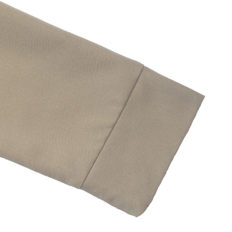 A close-up of a beige fabric sleeve cuff with a clean diagonal fold, shown on a solid white background.