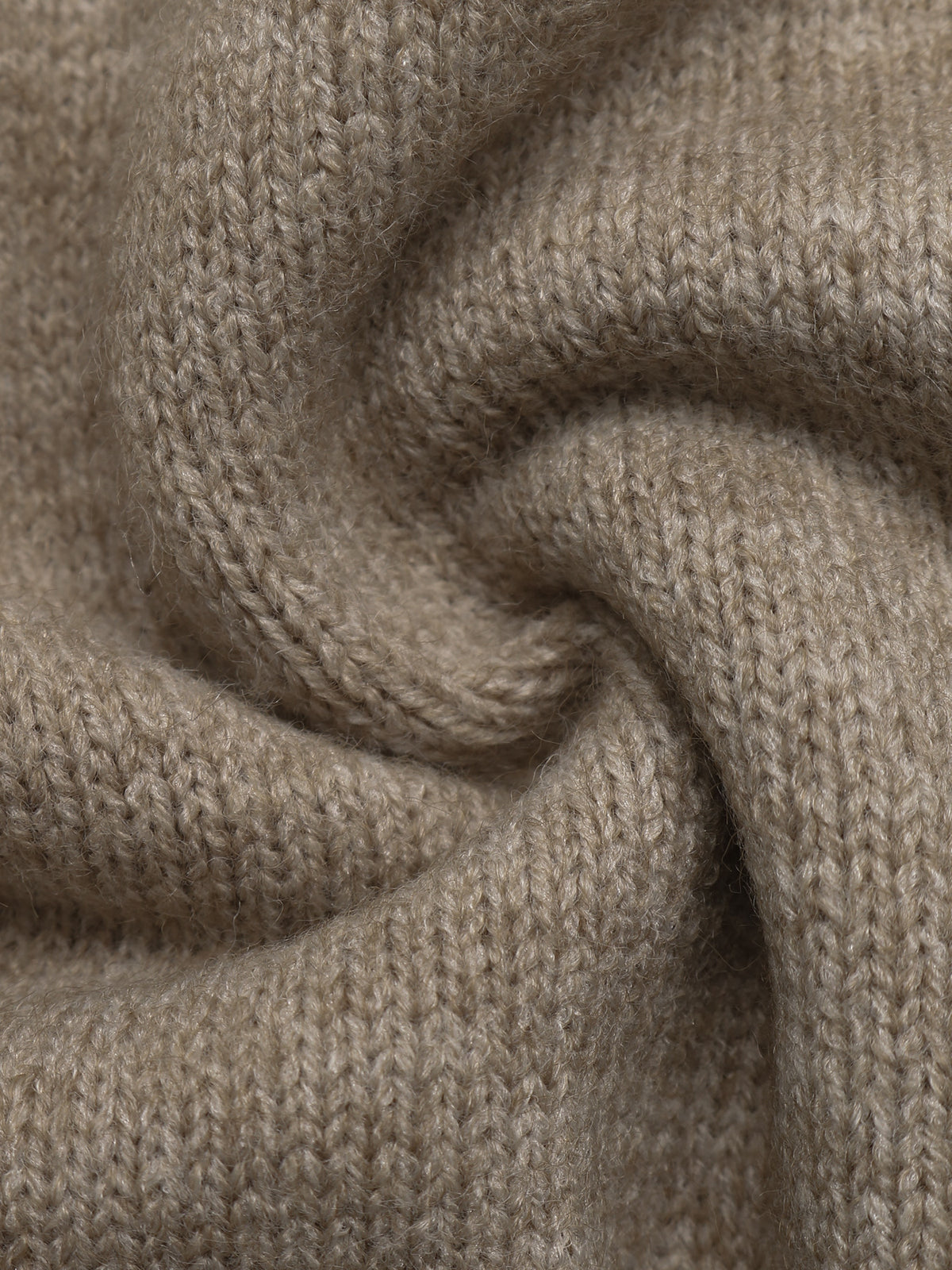A close-up of a soft, knitted fabric in a warm taupe-beige color, arranged in a gentle spiral drape to show the texture and weave.