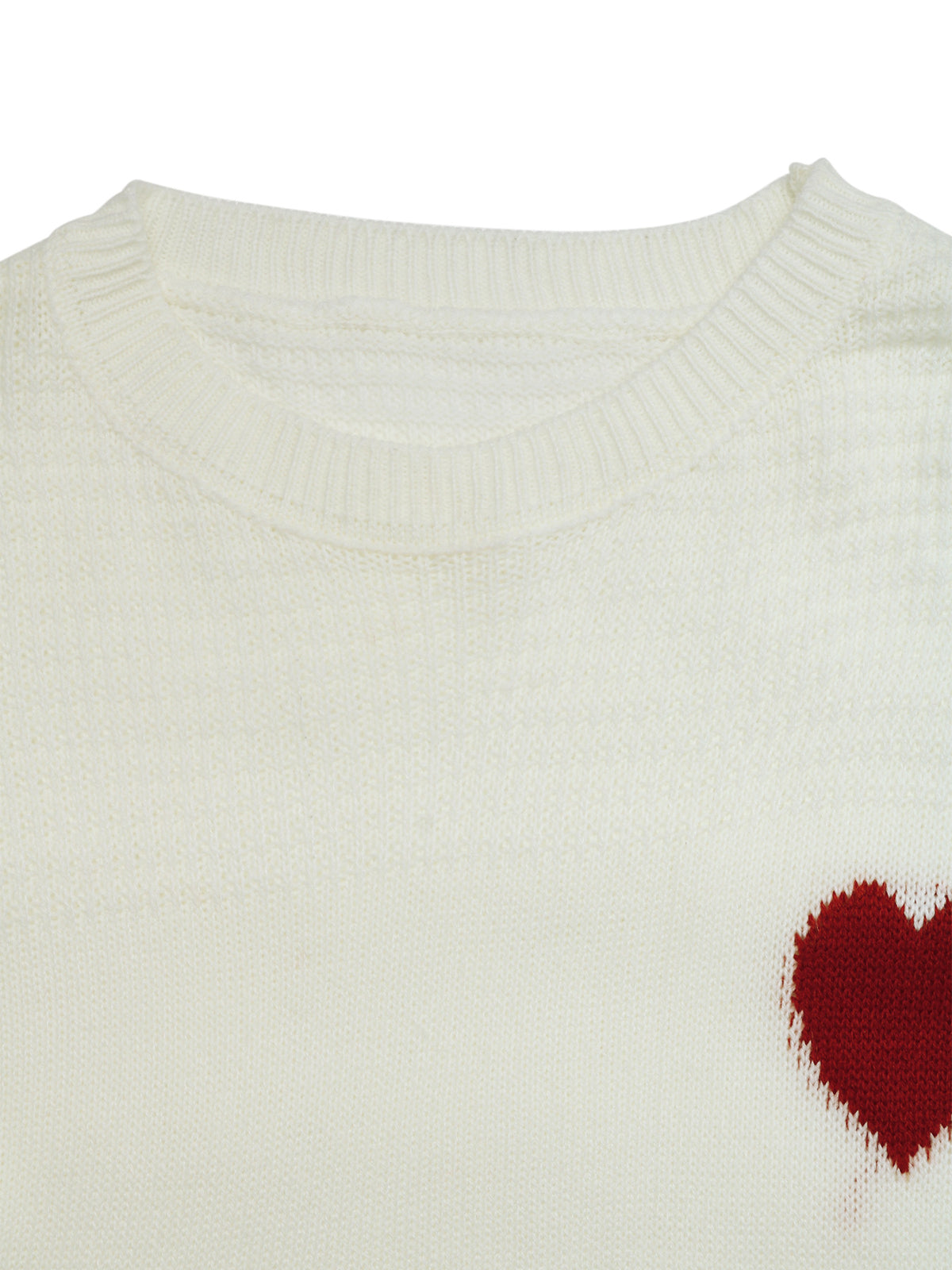 Close-up of a cream-colored knit sweater with a textured waffle pattern and a small red heart knit on the lower right chest, set against a plain white background.