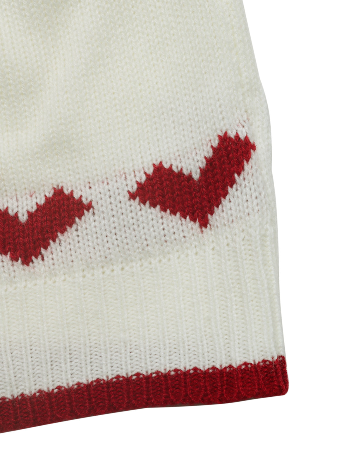 Close-up of a white knit textile with red heart motifs and a red ribbed hem on a white background.