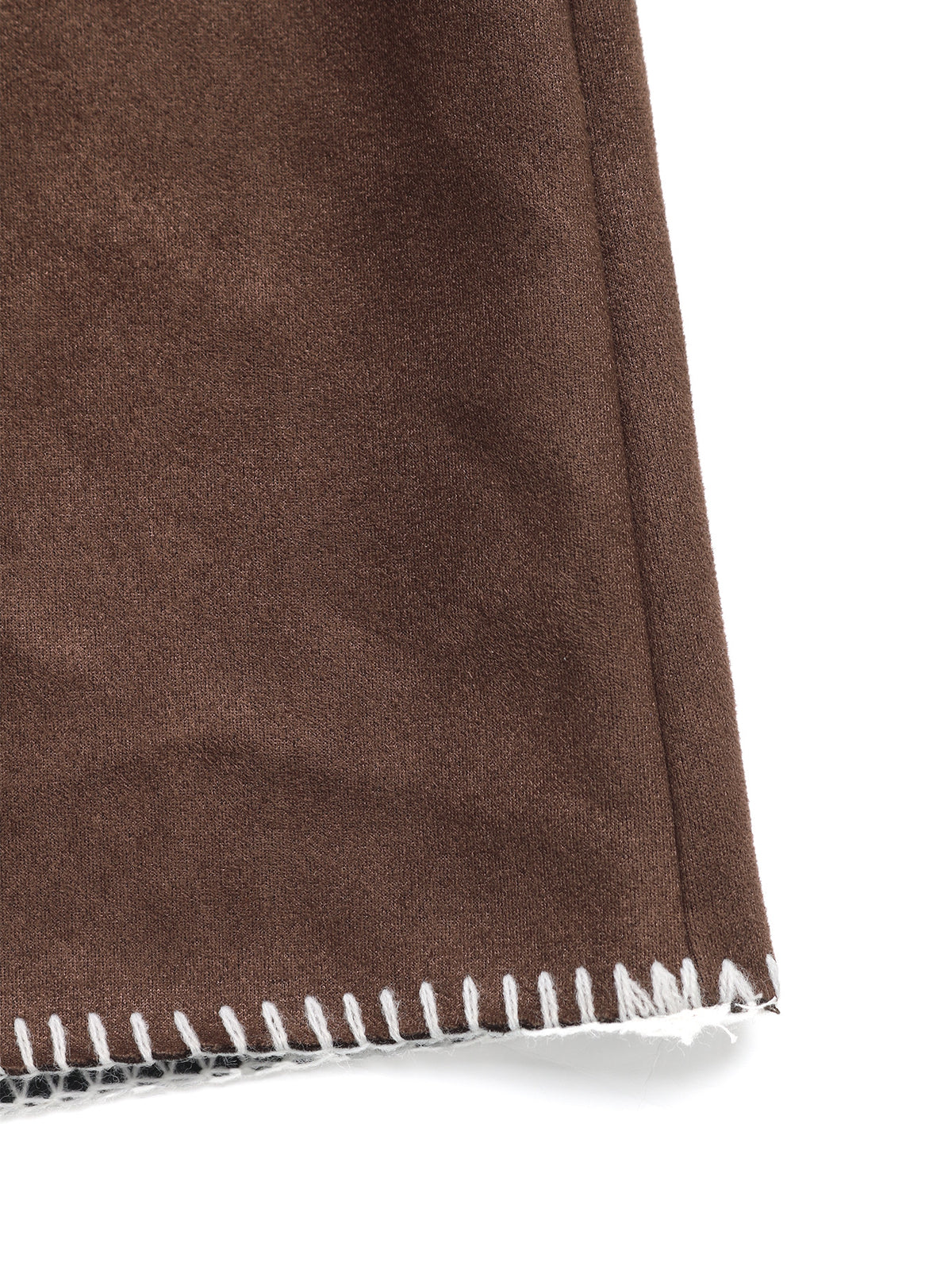 Close-up of a brown suede or faux-suede textile corner with white fringed trim on a white background.