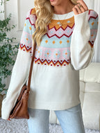 Person wearing a colorful patterned sweater with a neutral background