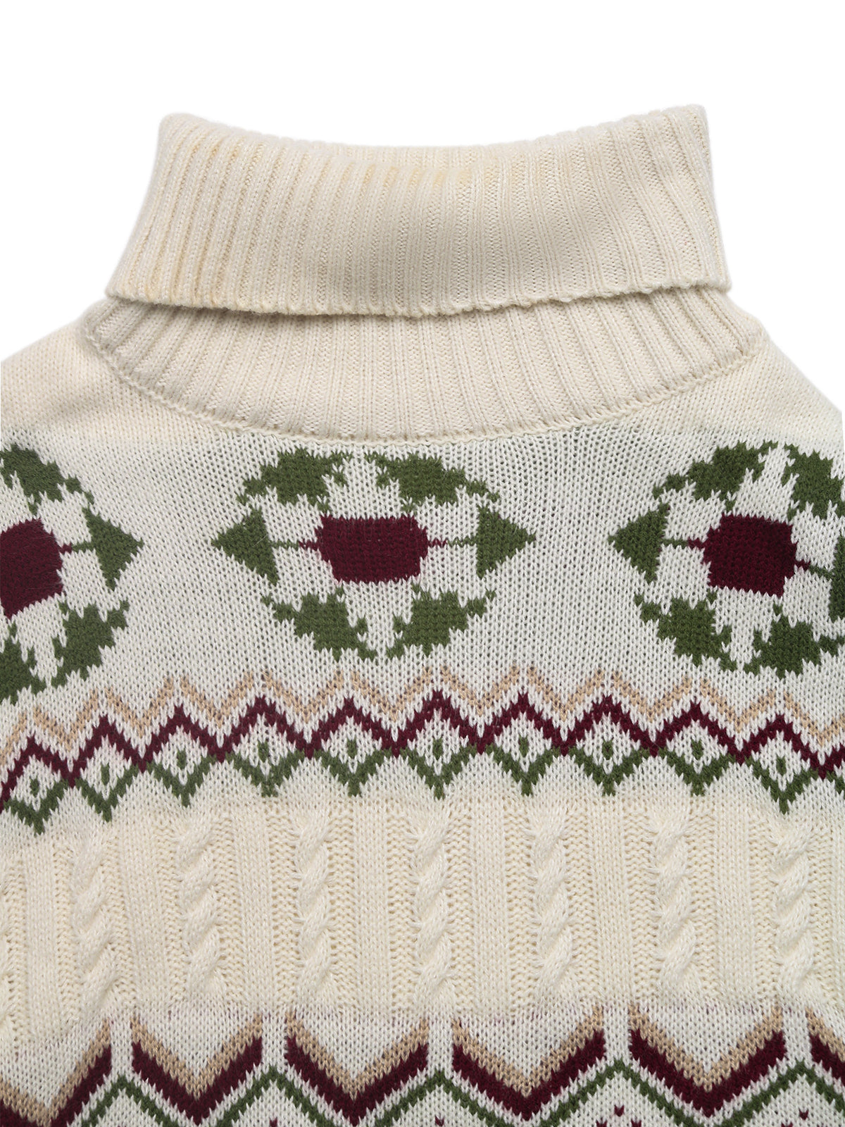 Close-up of a cream-colored sweater with green and red pattern on a white background