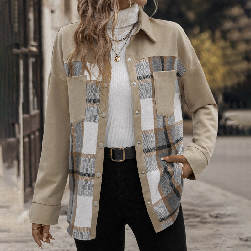 Person wearing a beige plaid shirt over a white turtleneck sweater.
