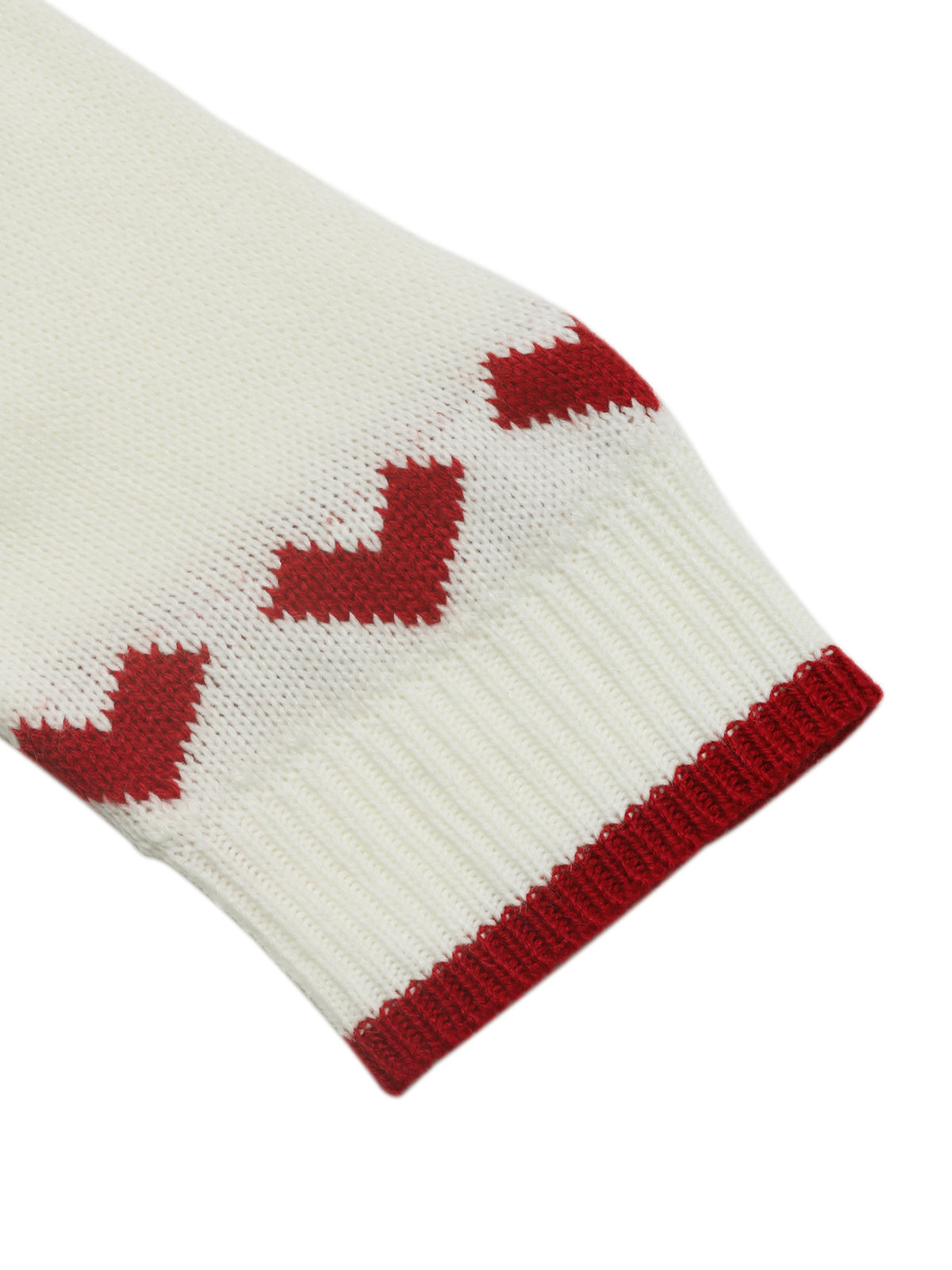 Close-up of a white knitted item with red geometric patterns on a white background
