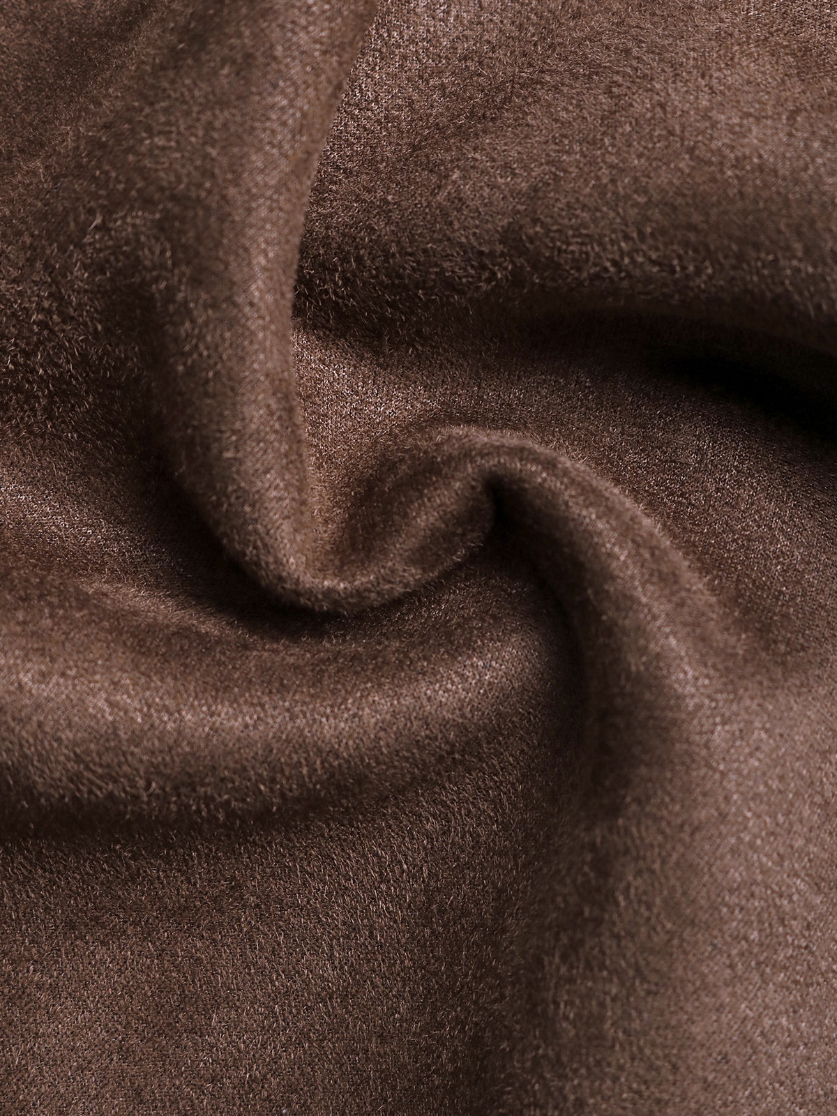 A close-up of draped brown fabric with a soft, slightly fuzzy texture and gentle folds.