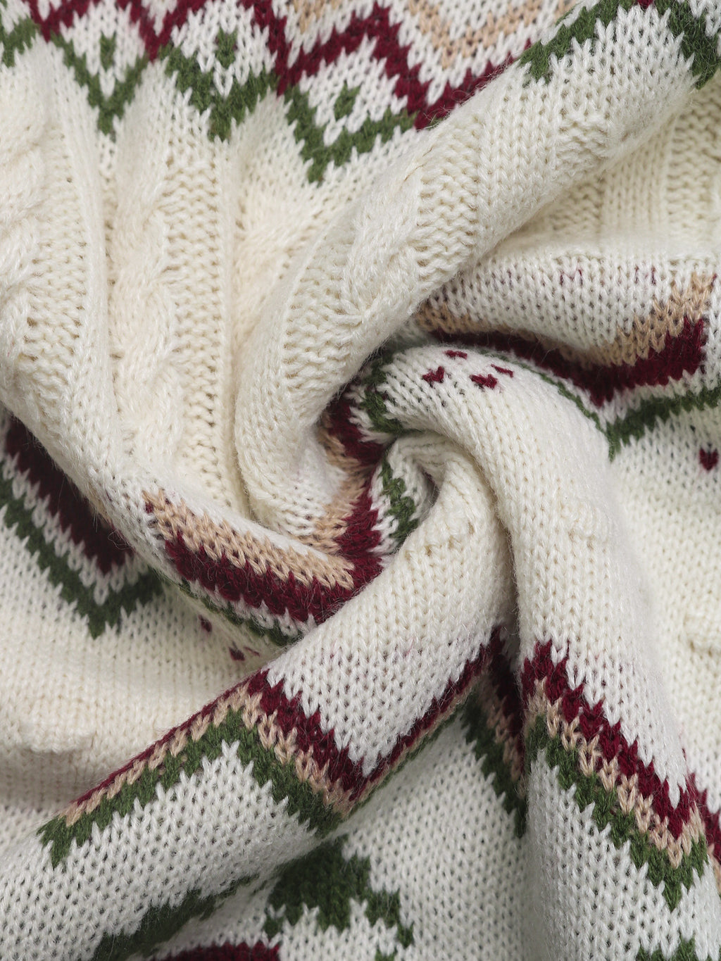 Close-up of a knitted fabric with a pattern featuring white, green, and red colors.