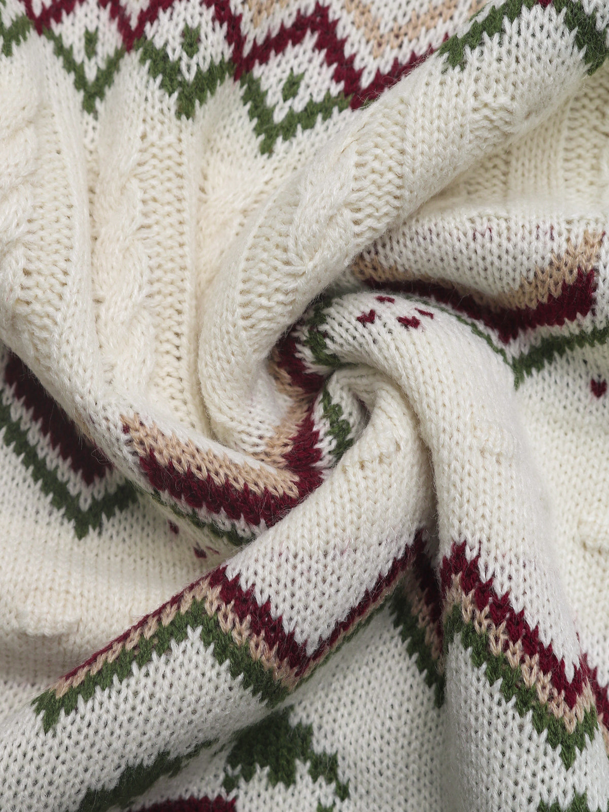 Close-up of a knitted fabric with a pattern featuring white, green, and red colors.